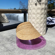 Raffia straw visor in lavender by LYKKE. Chic and modern straw visor with pvc brim.