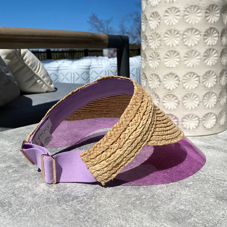 Raffia straw visor in lavender by LYKKE. Chic and modern straw visor with pvc brim.